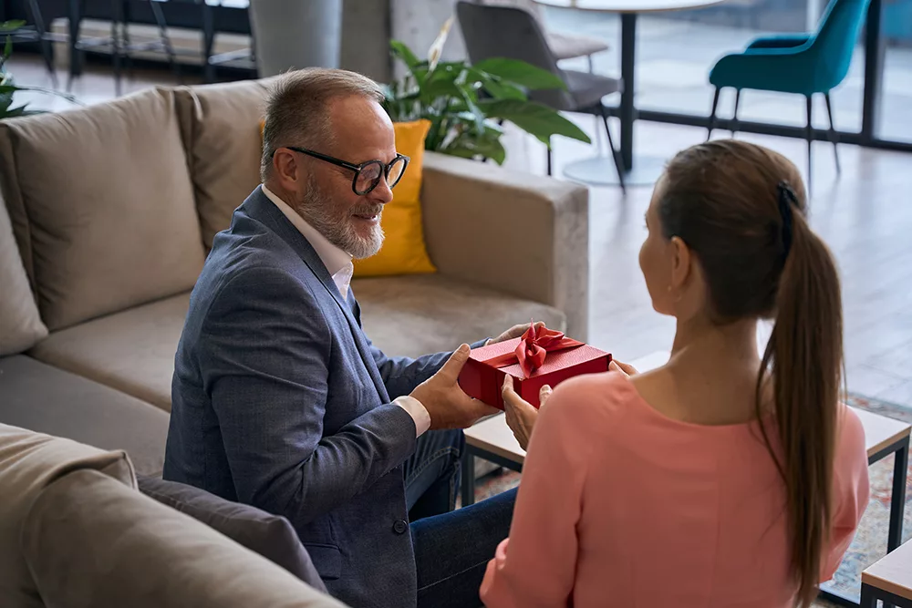 woman gives a gift box to man in gray jacket 2023 03 15 21 30 08 utc